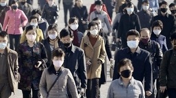 FILE PHOTO: People wearing protective face masks commute amid concerns over the new coronavirus disease (COVID-19) in Pyongyang, North Korea.