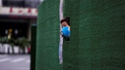 A resident looks out through a gap in the barrier at a residential area during lockdown, amid the coronavirus disease (Covid-19) pandemic, in Shanghai, China.