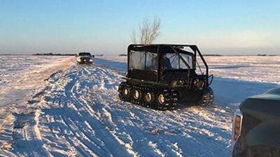 Snow and vehicles are seen as RCMP officers search the area where a family of four froze to death after crossing the border from the US near Emerson, Manitoba, Canada. (Reuters File Photo)