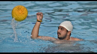A swimmer playing water polo at the PAU swimming pool in Ludhiana on Monday, (Harvinder Singh/HT) A swimmer playing water polo at the PAU swimming pool in Ludhiana on Monday, (Harvinder Singh/HT)