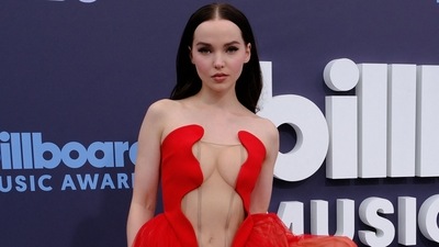 US actress Dove Cameron attends the 2022 BBMAs in a red gown featuring a plunging neckline extending up till her waist. (AFP) US actress Dove Cameron attends the 2022 BBMAs in a red gown featuring a plunging neckline extending up till her waist. (AFP)