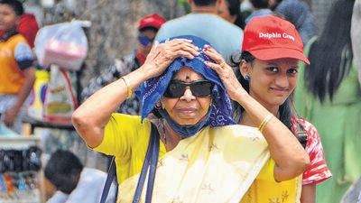 Visitors at Rock Garden turning to caps and scarves for protection amid the searing heat in Chandigarh on Monday afternoon. (Keshav Singh/HT)