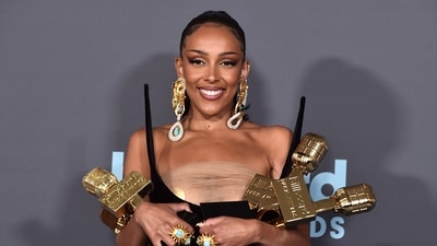 Doja Cat poses in the press room with the awards for top R&B artist, top R&B female artist, top viral song for "Kiss Me More" and top R&B album for "Planet Her" at the Billboard Music Awards. (Jordan Strauss/Invision/AP) Doja Cat poses in the press room with the awards for top R&B artist, top R&B female artist, top viral song for "Kiss Me More" and top R&B album for "Planet Her" at the Billboard Music Awards. (Jordan Strauss/Invision/AP)