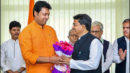 Tripura chief minister Manik Saha with former chief minister Biplab Kumar Deb during a ceremony for MLAs to take oath as Cabinet Ministers in Agartala on Monday. (PTI PHOTO.) Tripura chief minister Manik Saha with former chief minister Biplab Kumar Deb during a ceremony for MLAs to take oath as Cabinet Ministers in Agartala on Monday. (PTI PHOTO.)