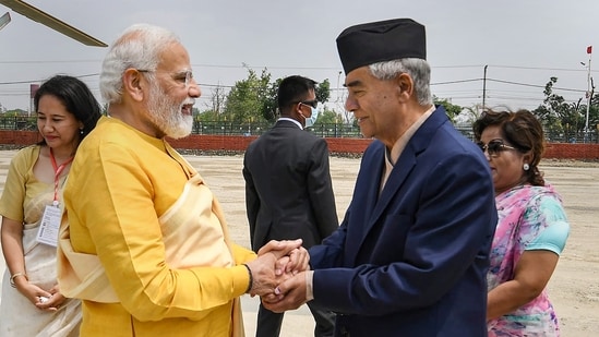 Prime Minister Narendra Modi being greeted by Nepal PM Sher Bahadur Deuba as he arrives in Lumbini, the birth place of Lord Buddha.&nbsp;(PTI)