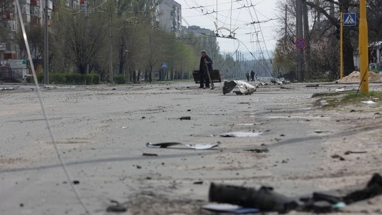 A local resident walks along an empty street with residential buildings damaged by a military strike in Sievierodonetsk, Luhansk region, Ukraine. (File image)(REUTERS)