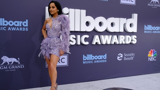 US singer Becky G arrived at the 2022 Billboard Music Awards in a lavender one-shoulder mini dress featuring feather embellishments, intricate sequin work, matching belt cinched on the waist and a bodycon silhouette. Open tresses, minimal jewellery and glam makeup rounded it all off.&nbsp;(AFP)