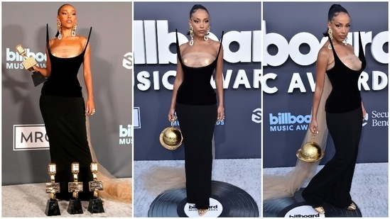 Doja Cat attended the BBMAs dripping in gold as she unveiled her surreal look by Schiaparelli creative director Daniel Roseberry. The rapper donned a sculptural black corset gown in moulded velvet and crepe bodycon skirt, adorned with a nude tulle fabric wrapped around her chest and trailing behind to form a train.(Reuters, AP)