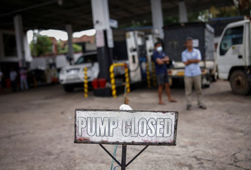 People wait in a queue to buy petrol at a closed fuel station, amid the country's economic crisis in Colombo, Sri Lanka, on Monday.&nbsp; (REUTERS)