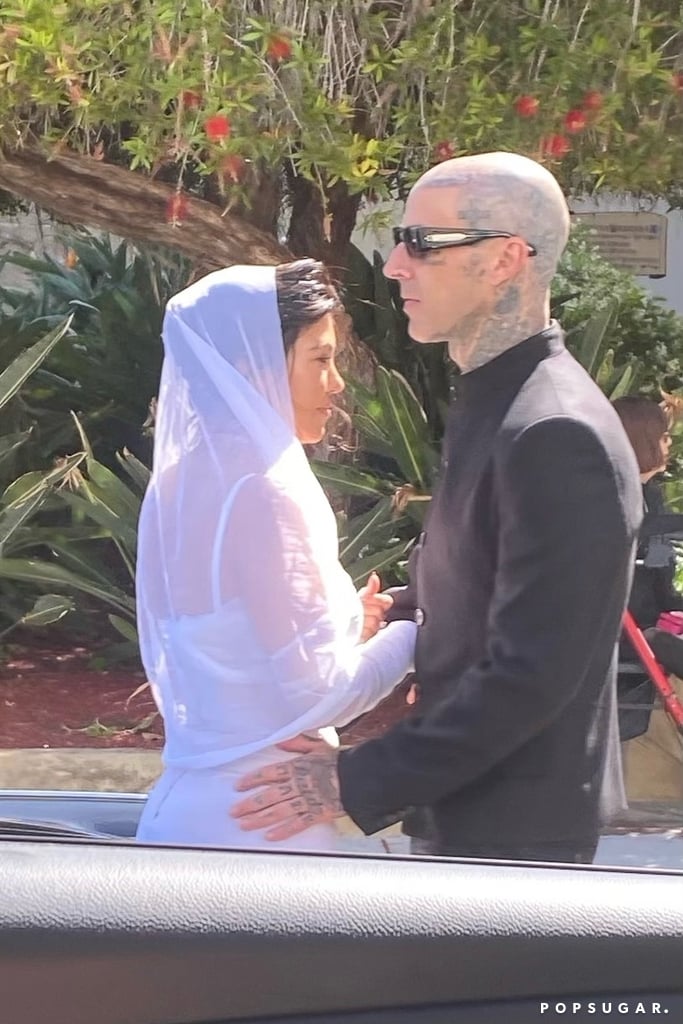 Kourtney and Travis are seen in their wedding looks from the Sunday ceremony. Kourtney and Travis are seen in their wedding looks from the Sunday ceremony.