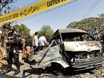 Police officers and crime scene unit gather near a passenger van, after a blast at the entrance of the Confucius Institute, University of Karachi, Pakistan April 26, 2022 (REUTERS) Police officers and crime scene unit gather near a passenger van, after a blast at the entrance of the Confucius Institute, University of Karachi, Pakistan April 26, 2022 (REUTERS)