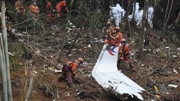 Workers conduct search for the black box near the debris at the China Eastern flight crash site in Tengxian County in southern China's Guangxi Zhuang Autonomous Region on March 24, 2022. (AP)