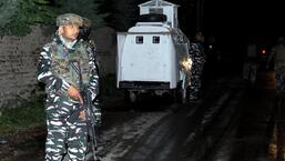 Security personnel cordon off the area after a grenade attack on a wine shop in Baramulla on Tuesday. A burqa-clad terrorist walked up to a newly-opened shop, dropped a grenade inside through the porthole window, causing an explosion which killed one employee and left three others injured (PTI)