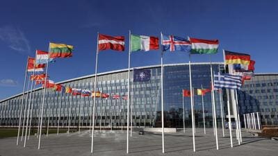 Flags flutter in the wind outside Nato headquarters in Brussels, Belgium. (AP) Flags flutter in the wind outside Nato headquarters in Brussels, Belgium. (AP)