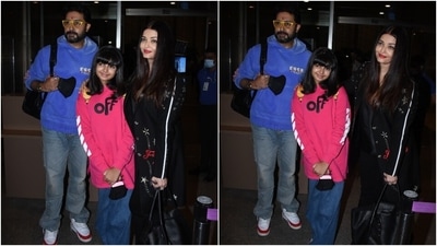 Aishwarya chose an all-black theme for her airport look. The actor slipped into a black silk satin shirt and skinny pants set, layered with a black embellished coat featuring a contrast white lining. She styled the ensemble with open tresses, black heeled boots, a matching tote bag, red lips, and minimal make-up. (HT Photo/Varinder Chawla)