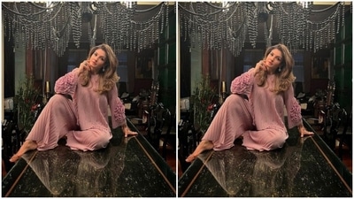 Raveena paired a full-sleeved cropped top with dramatic quarter sleeves with a pair of satin trousers with wide legs. (Instagram/@officialraveenatandon)