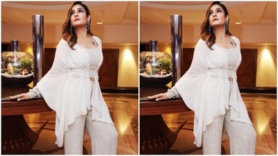 Raveena paired a white cropped top embellished with white sequins with a pair of sequined white trousers with wide legs. She added more drama to her look with a white satin drape tied around herself with a decorated white embellished belt at the waist. (Instagram/@officialraveenatandon)