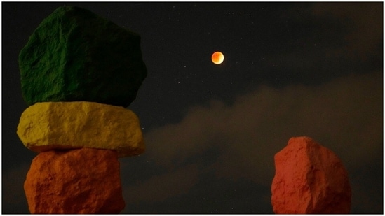 The moon was captured in between an art installation in Jean, Nev.(AP Photo)