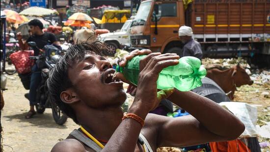 A man drinks water to quench his thirst on a hot summer day, in New Delhi, on Tuesday. (PTI)