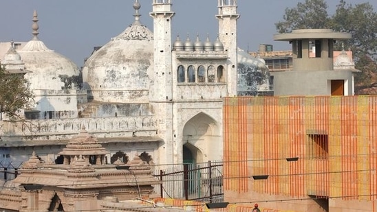 FILE PHOTO: A worker stands on a temple rooftop adjacent to the Gyanvapi Mosque in the northern city of Varanasi, India, December 12, 2021. REUTERS/Pawan Kumar(REUTERS)