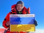 Ukraine's mountaineer Antonina Samoilova posing with a flag at the summit of the Mount Everest in Nepal.(AFP)