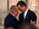 Spain's King Juan Carlos and his son Crown Prince Felipe (R) hug each other as they attend the signature ceremony of the act of abdication at the Royal Palace in Madrid.