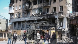 Local residents stand at a bus stop in Mariupol, in territory under the government of the Donetsk People's Republic, eastern Ukraine.