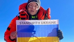Ukraine's mountaineer Antonina Samoilova posing with a flag at the summit of the Mount Everest in Nepal.