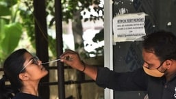 A health worker collects swab sample of a woman for Covid-19 testing. (Vipin Kumar/HT FILE PHOTO)