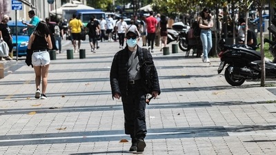 A pedestrian walks in the street wearing protective face mask in the center of Thessaloniki, northern Greece. (AFP) A pedestrian walks in the street wearing protective face mask in the center of Thessaloniki, northern Greece. (AFP)