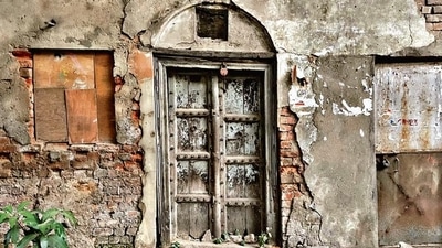 Studded with faded brasses, this is a traditional wood door you might chance upon in Old Delhi, or in any other historic neighbourhood such as Mehrauli. Studded with faded brasses, this is a traditional wood door you might chance upon in Old Delhi, or in any other historic neighbourhood such as Mehrauli.