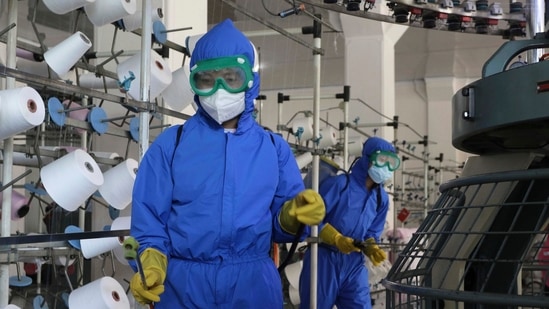 Employees of Songyo Knitwear Factory in Songyo district disinfect the work floor in Pyongyang, North Korea, Wednesday.(AP) Employees of Songyo Knitwear Factory in Songyo district disinfect the work floor in Pyongyang, North Korea, Wednesday.(AP)
