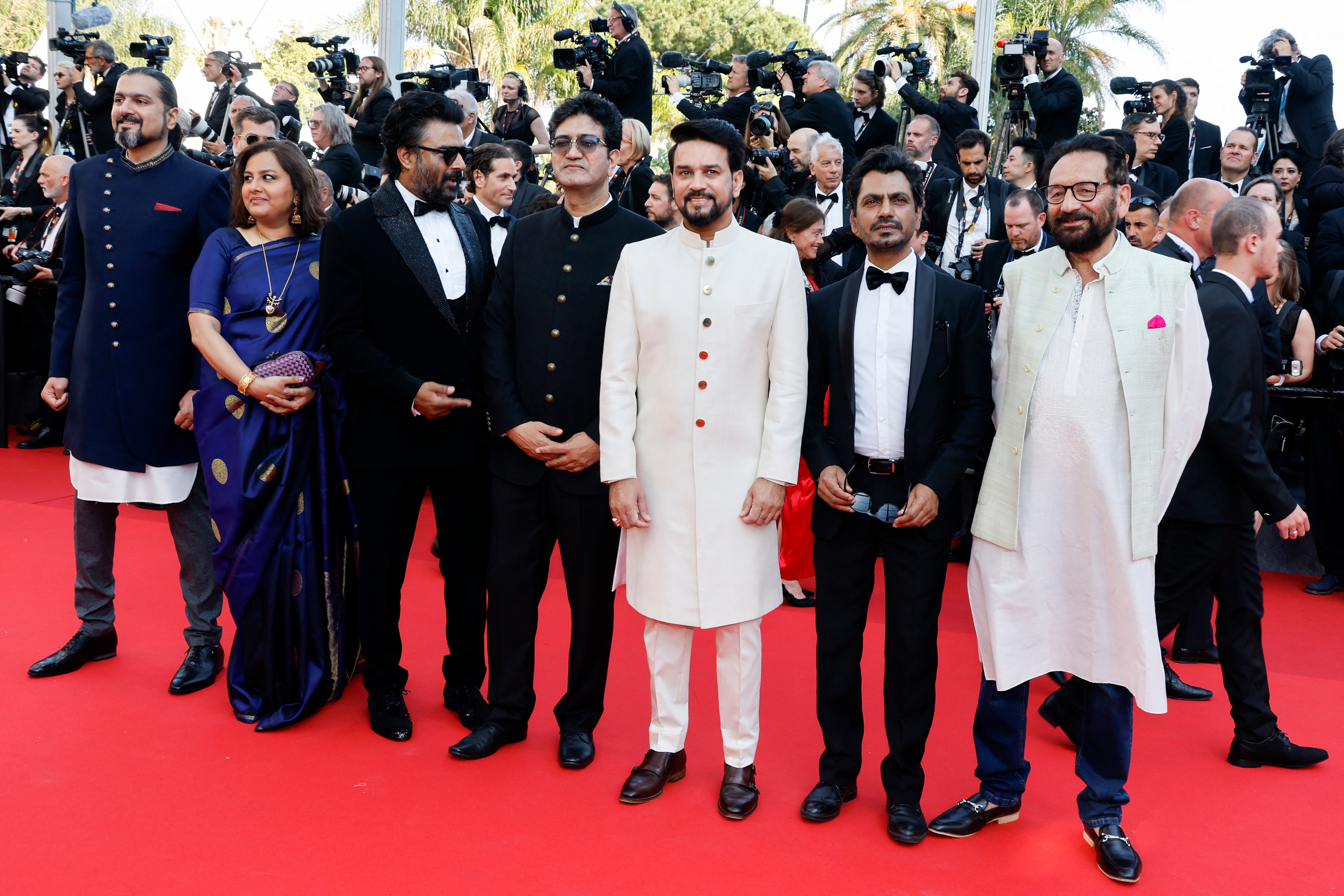 Ricky Kej, Vani Tripathi, R Madhavan, Prasoon Joshi, Anurag Thakur, Nawazuddin Siddiqui, and Shekhar Kapur pose at the opening ceremony of the 75th Cannes Film Festival. (Reuters) (REUTERS)