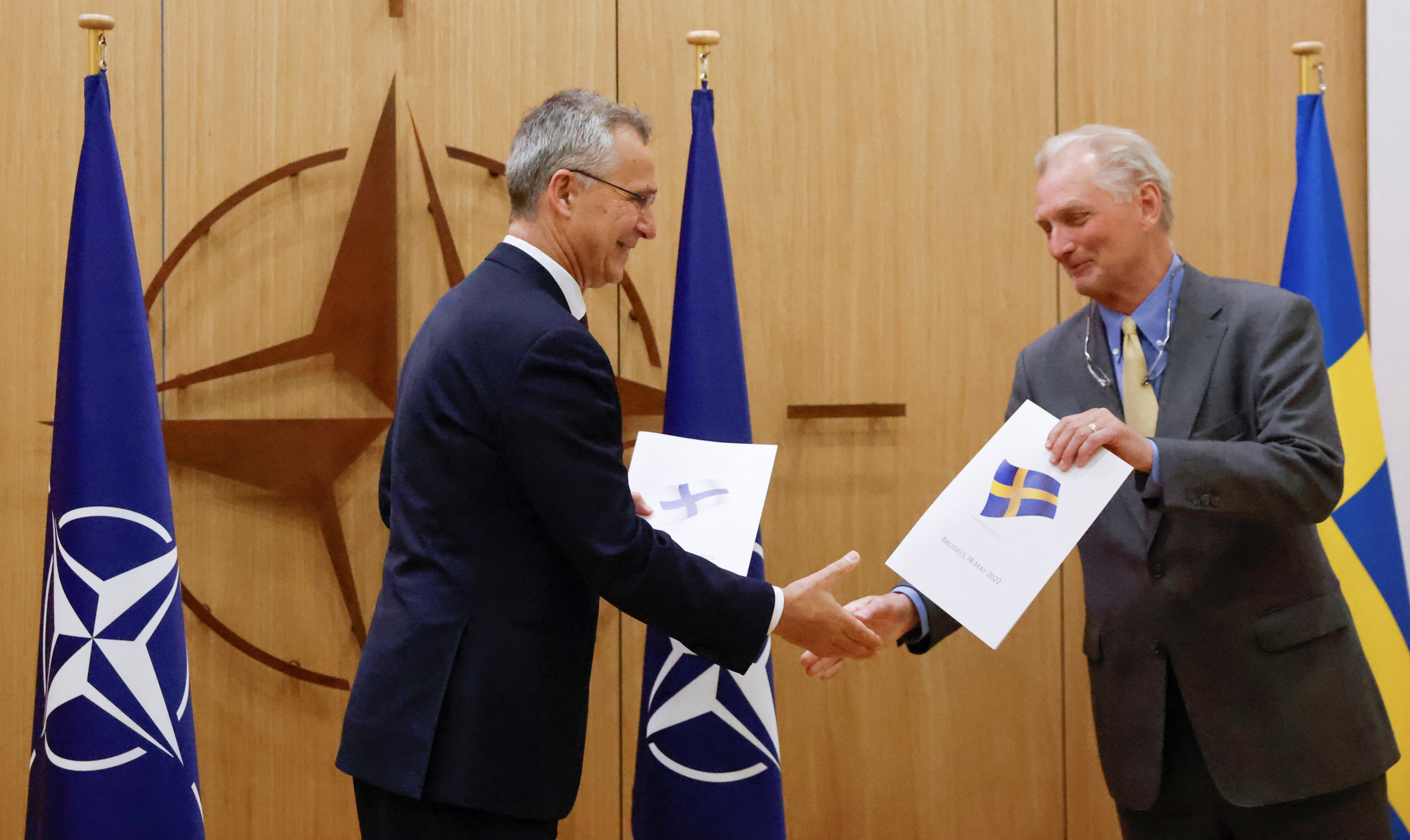 NATO Secretary-General Jens Stoltenberg and Sweden's Ambassador to NATO Axel Wernhoff shake hands during a ceremony to mark Sweden's and Finland's application for membership in Brussels, on May 18, 2022.&nbsp; (REUTERS)
