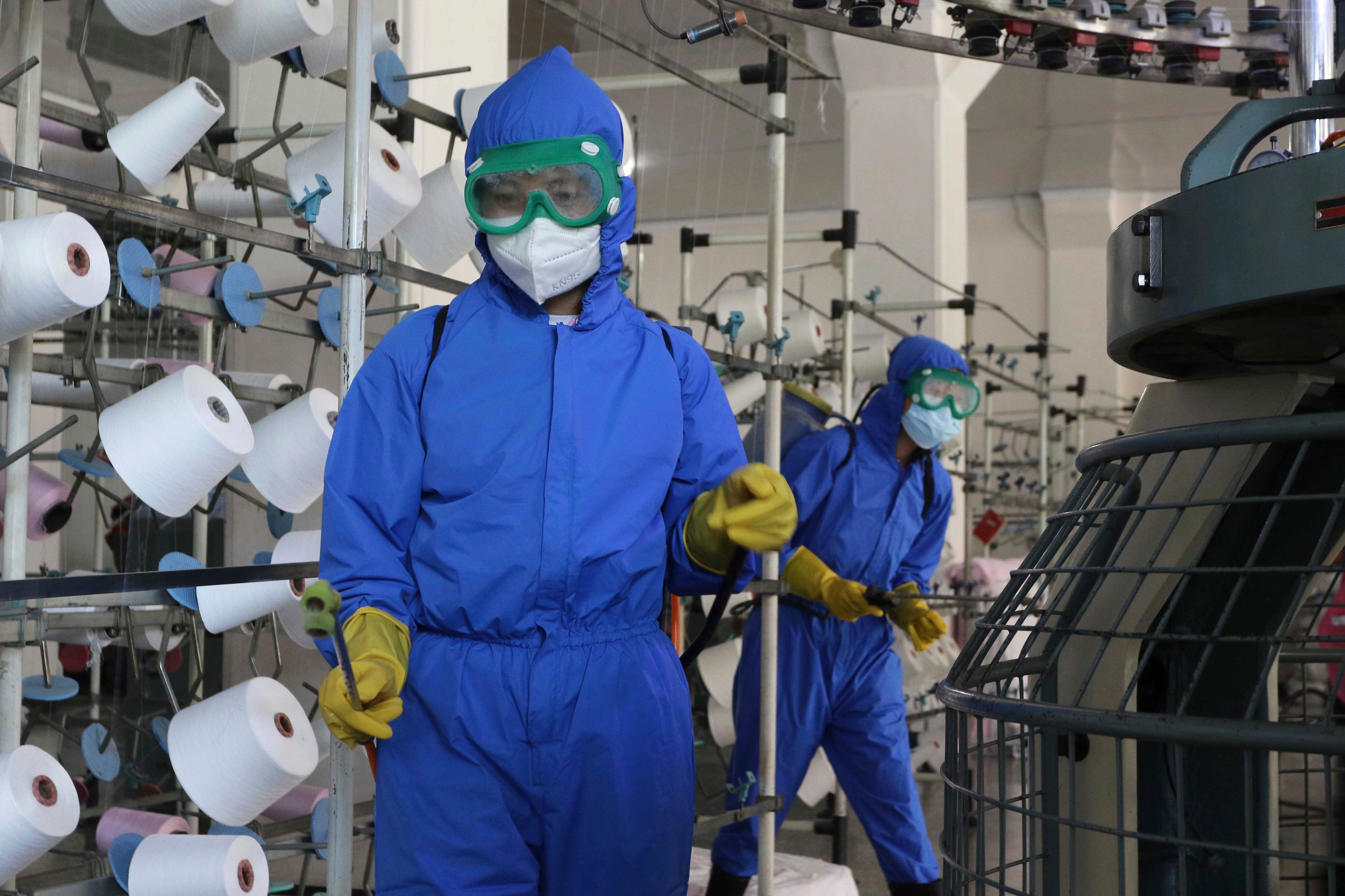 Employees of Songyo Knitwear Factory in Songyo district disinfect the work floor in Pyongyang, North Korea, Wednesday. (AP) Employees of Songyo Knitwear Factory in Songyo district disinfect the work floor in Pyongyang, North Korea, Wednesday. (AP)