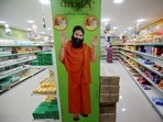A hoarding with an image of Baba Ramdev is seen inside a Patanjali store.(REUTERS) A hoarding with an image of Baba Ramdev is seen inside a Patanjali store.(REUTERS)
