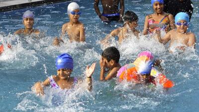Children splashing around in the pool to beat the heat at the Chandigarh Press Club on a hot Thursday afternoon. (Keshav Singh/HT)