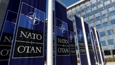 Banners displaying the NATO logo are placed at the entrance of new NATO headquarters during the move to the new building, in Brussels, Belgium. (REUTERS)