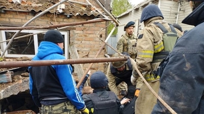 Police officers help rescue people from the rubble after an air strike, during Russia's invasion of Ukraine, in Bakhmut, Donetsk Region, Ukraine. (Reuters)