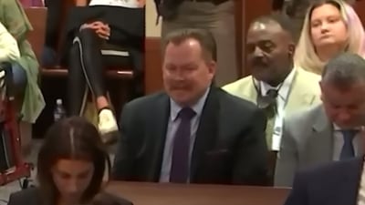 A still of the man laughing during the trial. A still of the man laughing during the trial. 