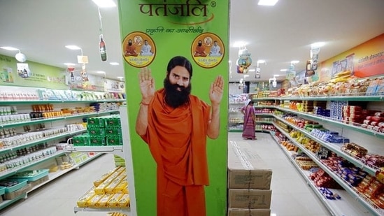 A hoarding with an image of Baba Ramdev is seen inside a Patanjali store.(REUTERS)