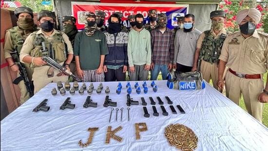 The arrested Lashkar-e-Taiba militants and a terror associate in the J&K Police custody on Thursday. (Photo: Baramulla police/Twitter)