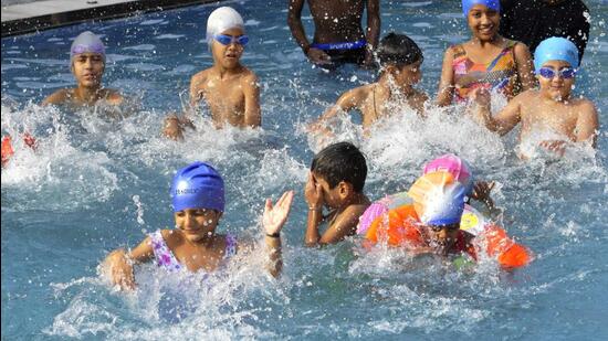 Children splashing around in the pool to beat the heat at the Chandigarh Press Club on a hot Thursday afternoon. (Keshav Singh/HT)