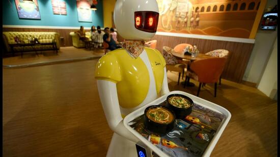The restaurant has 14 tables for customers and two robots serving them. According to its proprietors, the robots have cut down manpower by 25%. (Sunil Ghosh/HT Photo)