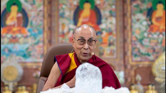 The Tibetan spiritual leader the Dalai Lama watching at a block of ice from the Khardung La glacier presented to him by India's climate activist Sonam Wangchuk (not pictured) on the occasion of the Earth Day in McLeod Ganj. (AFP)