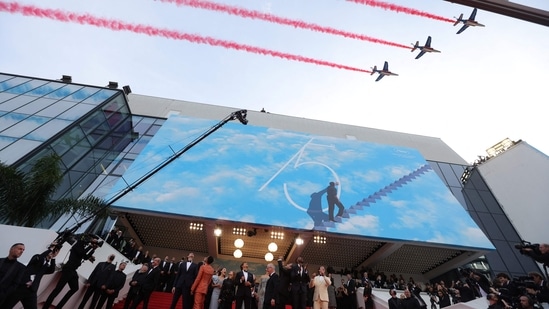 Tom Cruise, Jennifer Connelly arrive as the French elite acrobatic flying team Patrouille de France (PAF) flies over the Festival Palace for the screening of Top Gun: Maverick during the 75th edition of the Cannes Film Festival. (AFP)(AFP)