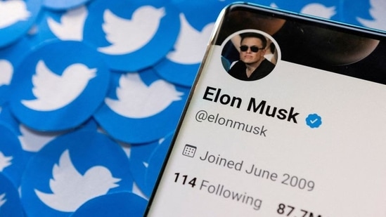 Elon Musk's Twitter profile is seen on a smartphone placed on printed Twitter logos in this picture illustration.(REUTERS)