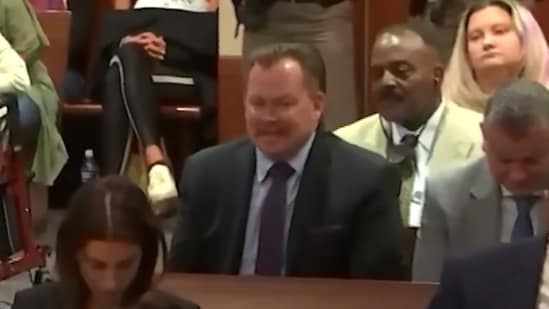 A still of the man laughing during the trial.&nbsp;