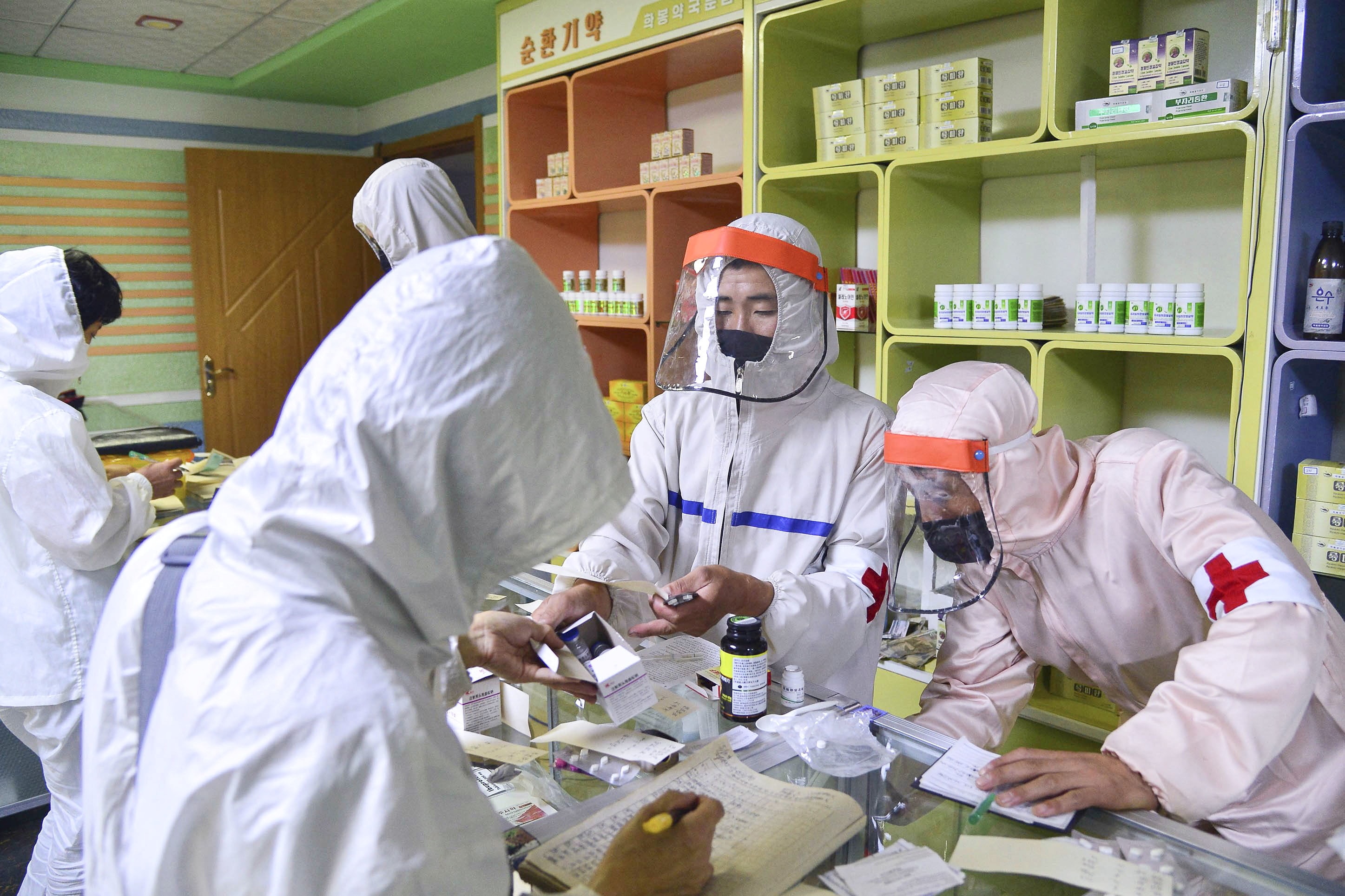 Members of the North Korean army supply medicines to residents at a pharmacy, amid growing fears over the spread of Covid-19, in Pyongyang, on May 18, 2022.&nbsp; (Kyodo via REUTERS)