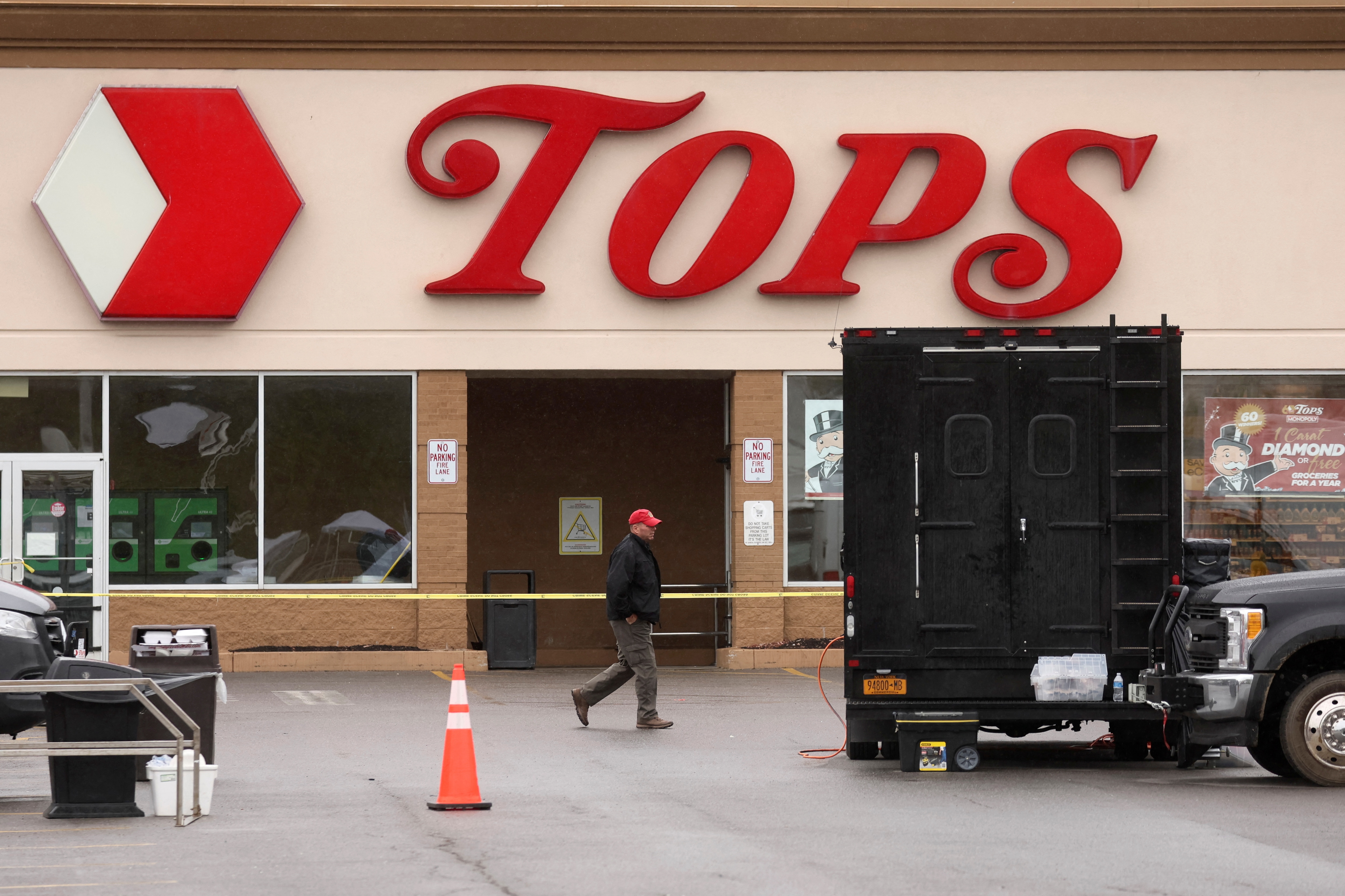A Member of the FBI search for evidence at the scene of a weekend shooting at a Tops supermarket in Buffalo, New York, on May 18, 2022.&nbsp; (REUTERS)